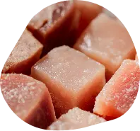 Close-up of pale pink frozen cubes of fresh pet food