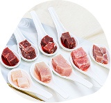 Spoons holding a variety of fresh raw proteins