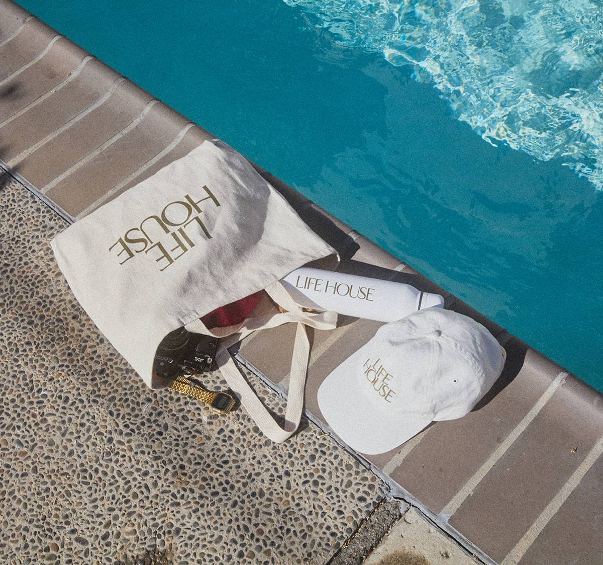 Life House custom poolside tote bag, water bottle, and white cap