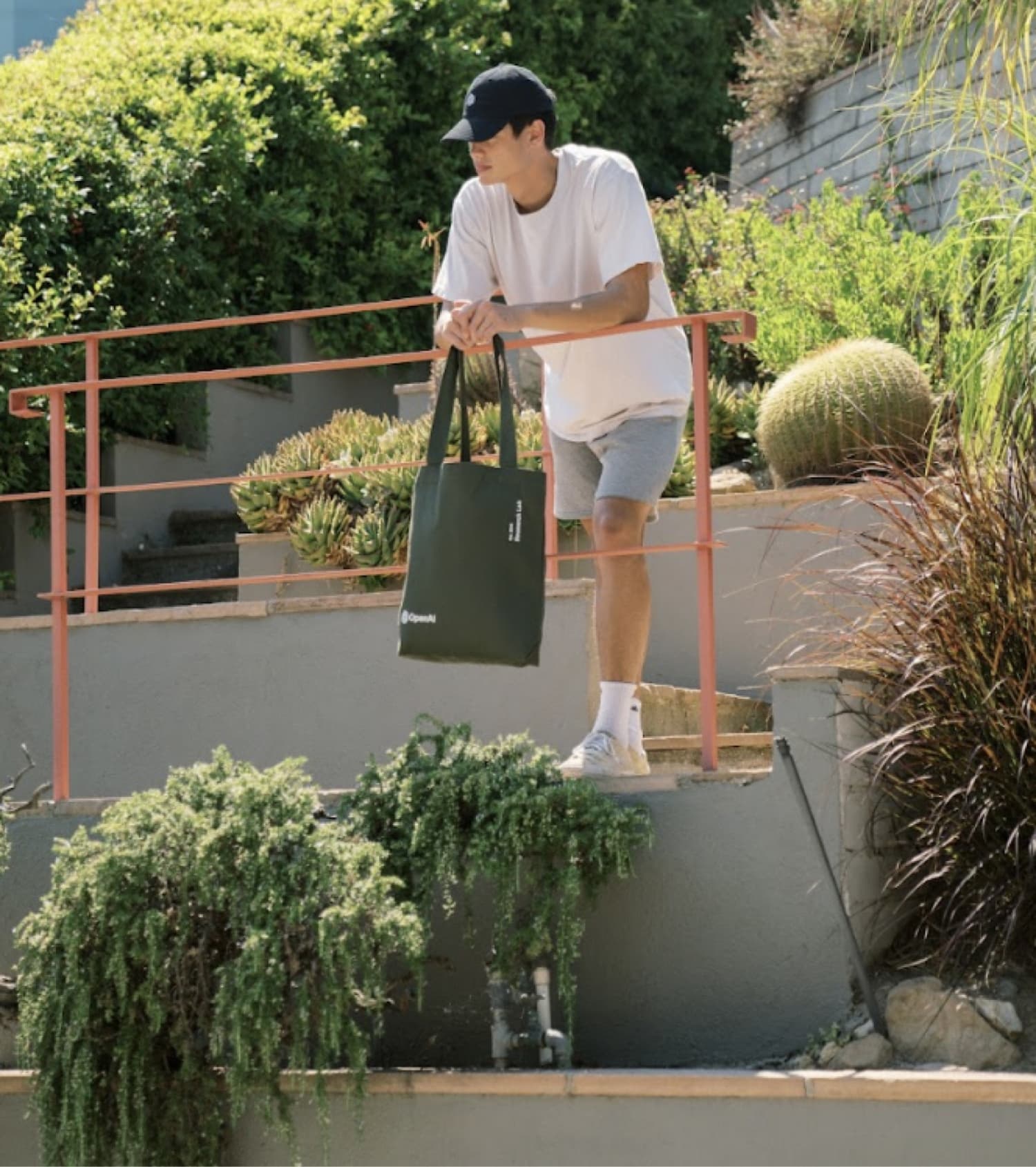 Model outside with OpenAI branded cap and tote