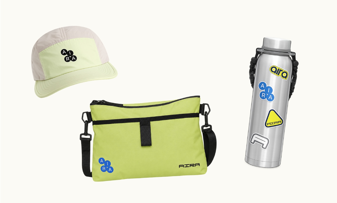 Aira branded cream cap, lime green cross bag, and stainless steel bottle with custom stickers