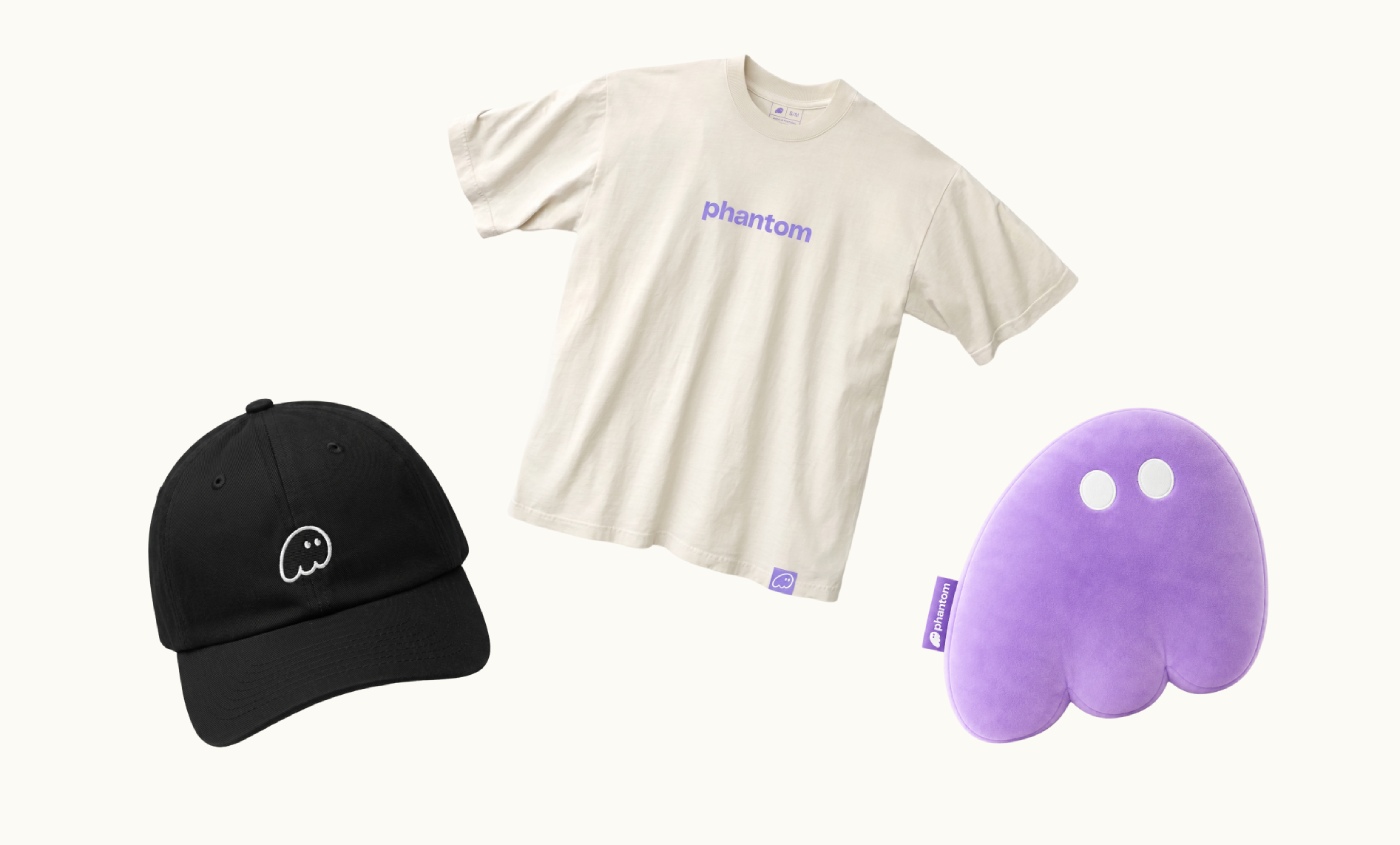 Phantom branded black beanie, cream tee and purple pillow