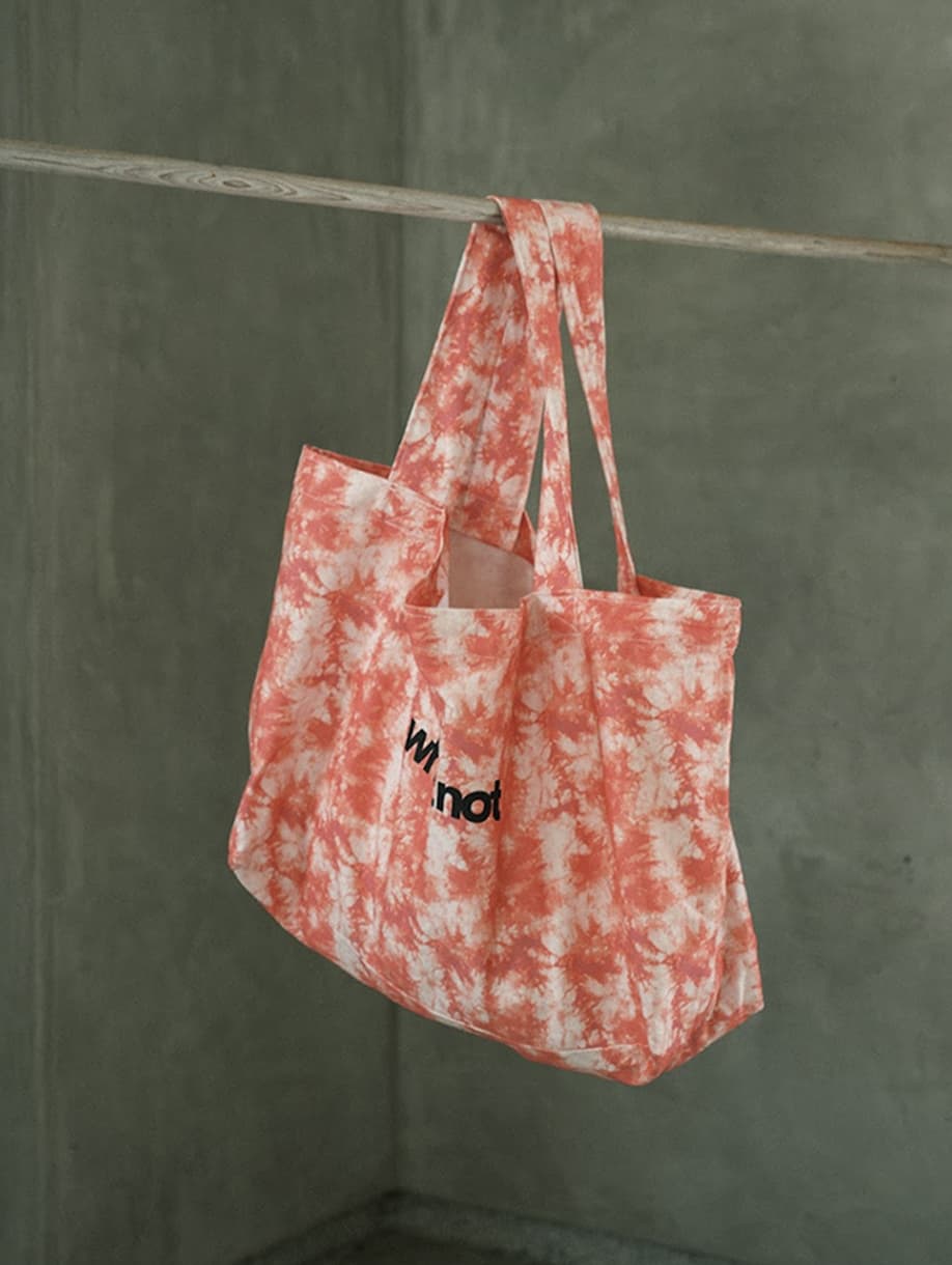 Whatnot custom orange tie-dye tote bag with black logo