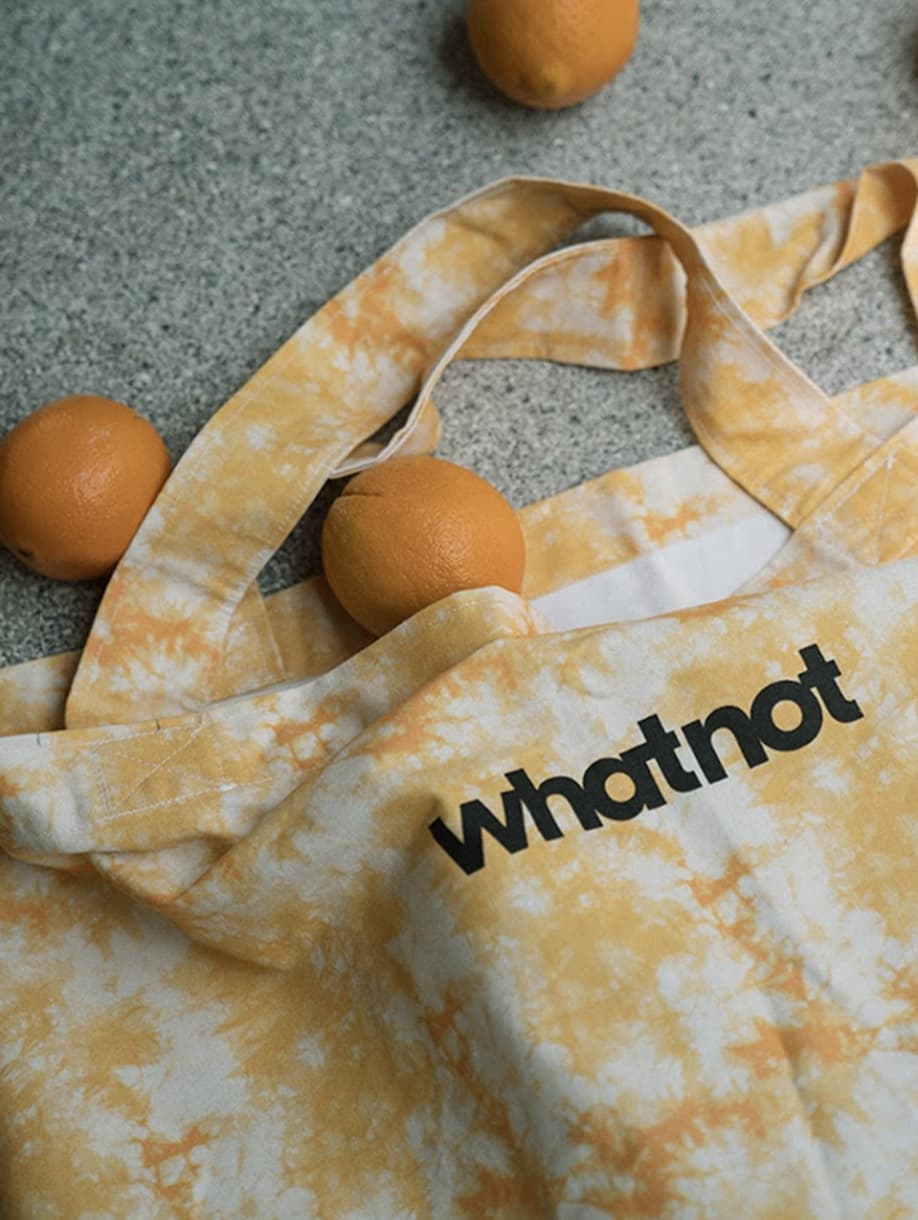 Whatnot custom yellow tie-dye tote bag with black logo