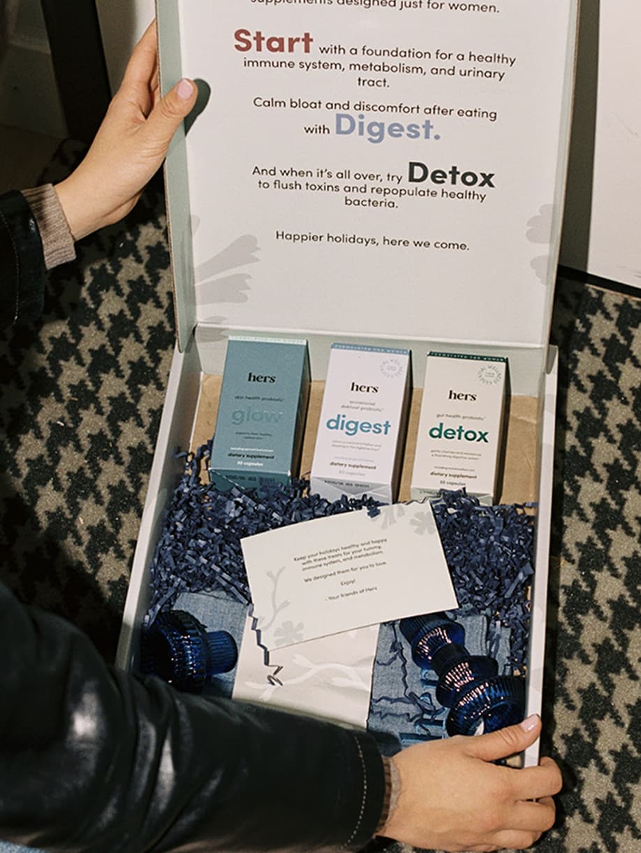 Hers custom wellness gift box with supplements, candles, and branded accessories