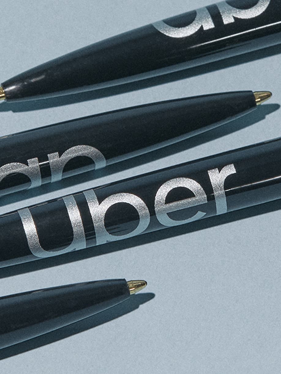 Close-up of custom black Uber branded pens