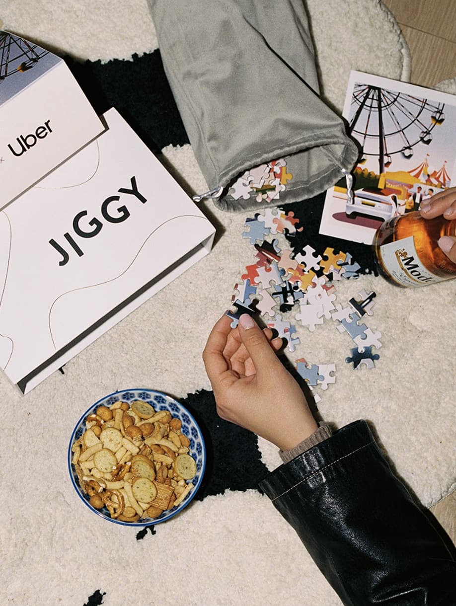 JIGGY x Uber custom puzzle being assembled with branded packaging