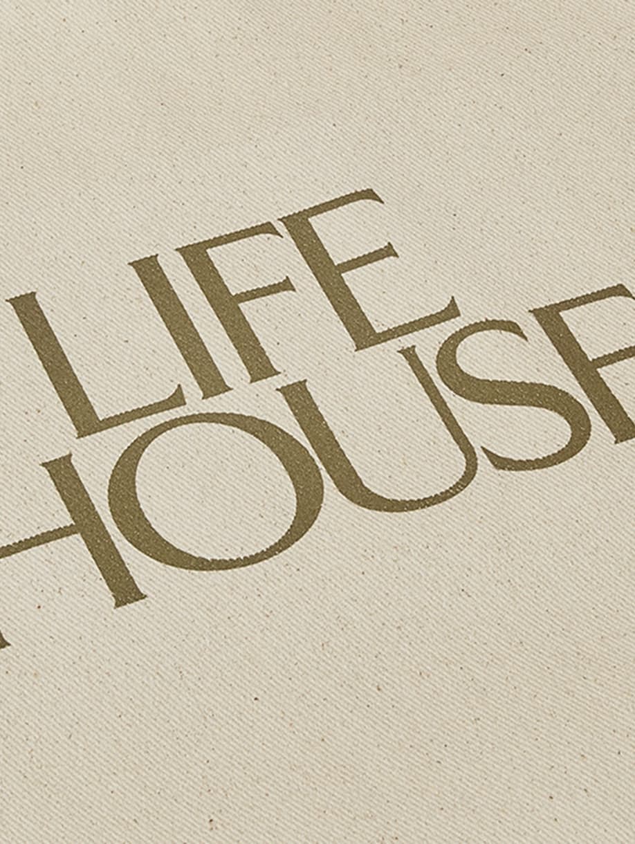 Close-up of Life House custom canvas tote bag with printed logo