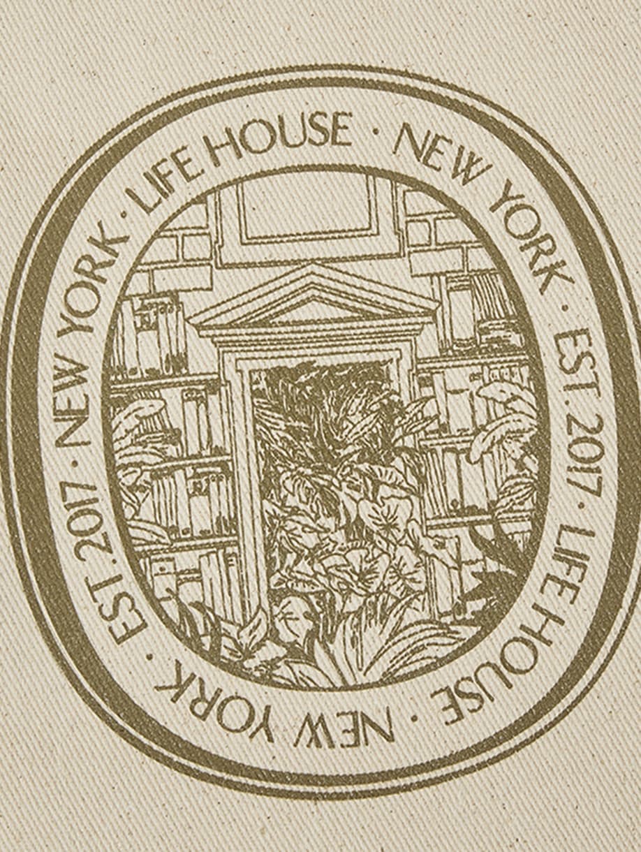 Close-up of Life House custom illustrated New York seal on canvas tote bag