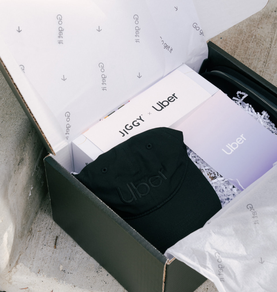 Jiggy x Uber opened welcome with branded merchandise inside including a black hat