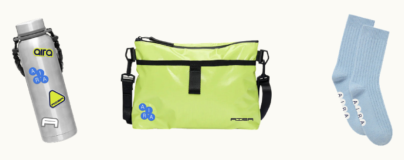 Aira branded merchandise featuring a stainless steel water bottle, neon crossbody bag and blue socks