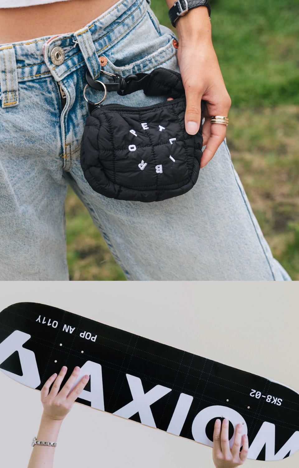 Custom black embroidered puffy accessory bag clipped to denim belt loop above branded sign