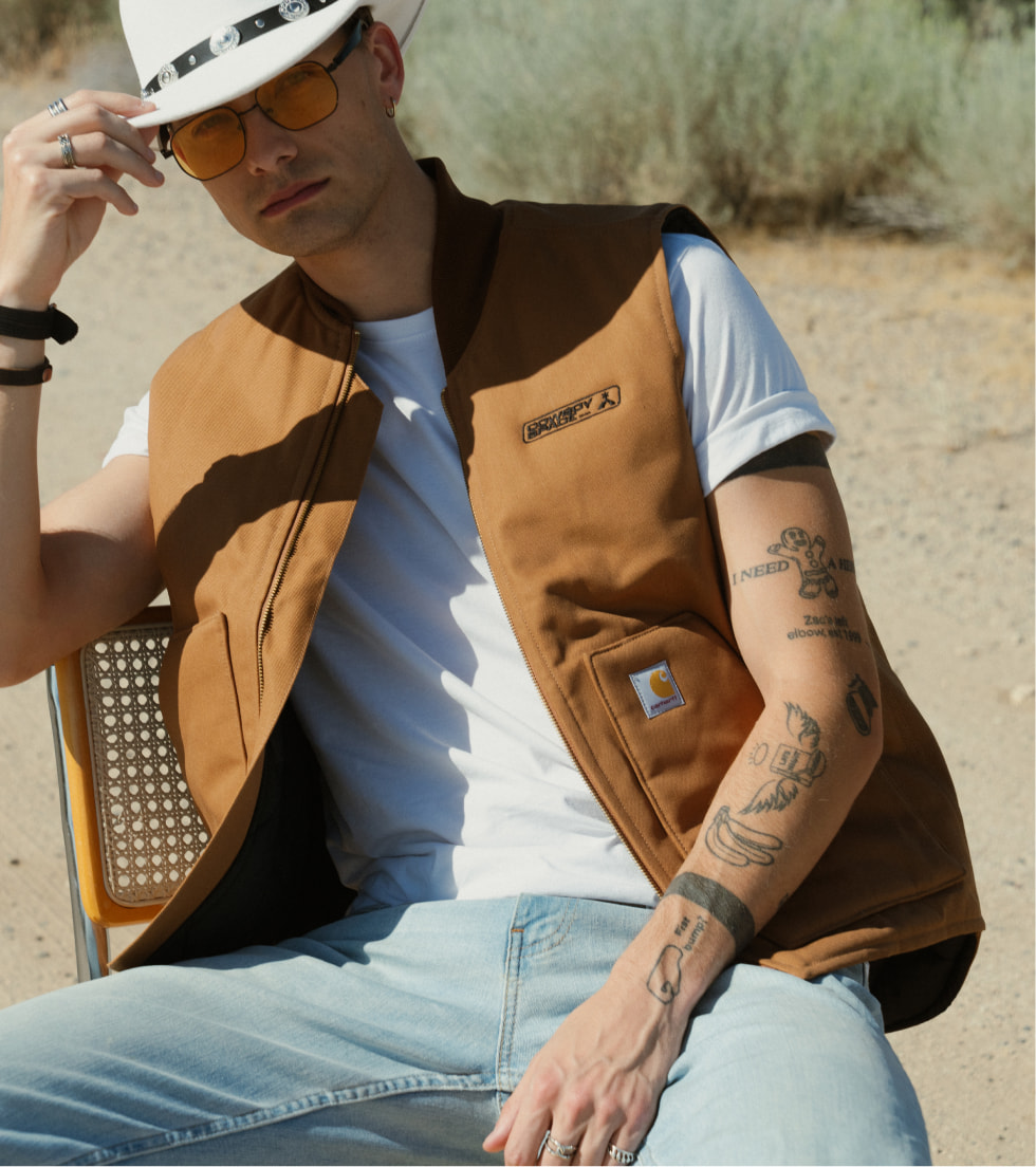 Model wearing a custom embroidered Carhartt vest outdoors