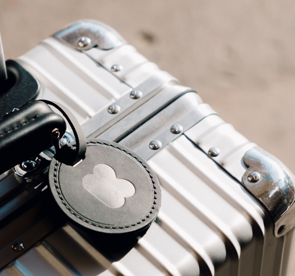 Custom black luggage tag with K branding in center