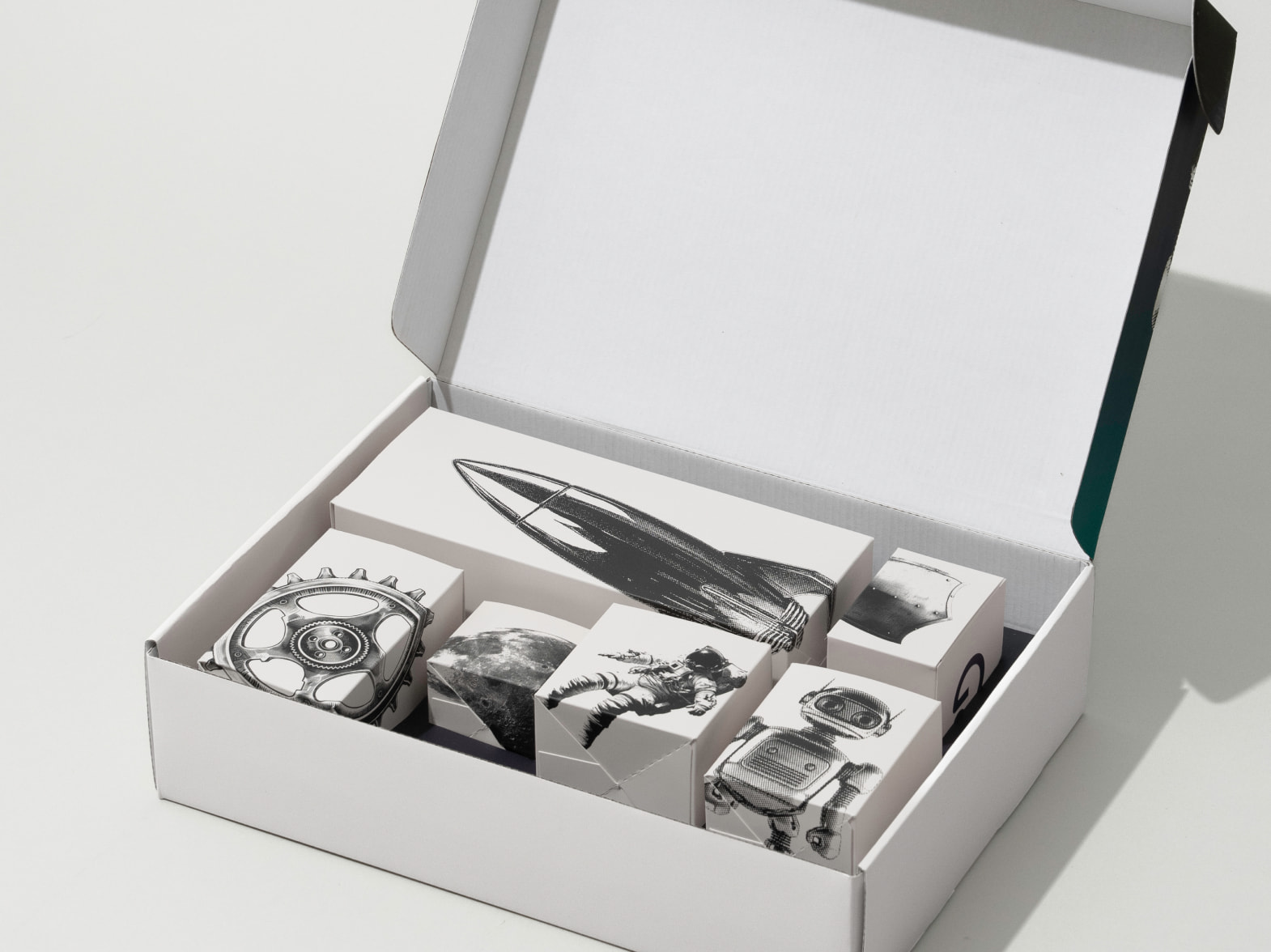 Black and white printed General Catalyst custom box opened to show smaller branded boxes inside