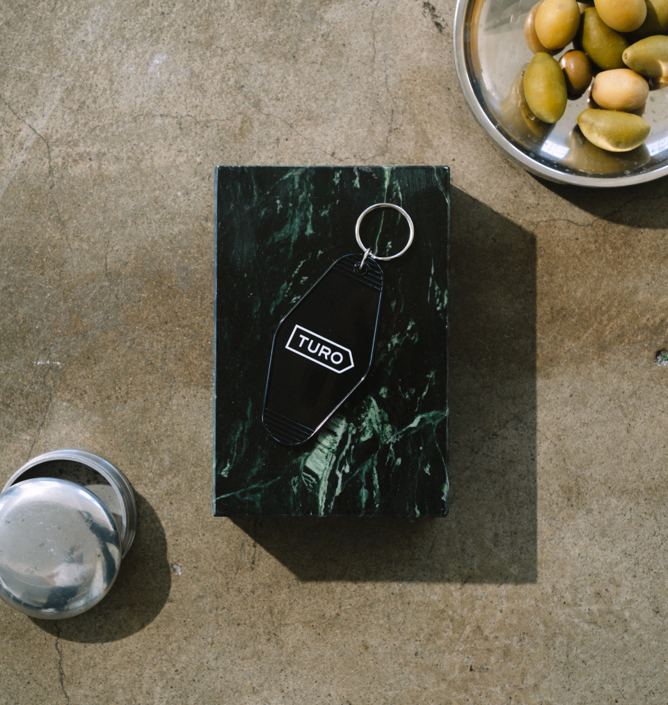 Black marble printed box with black Turo hotel keychain on top
