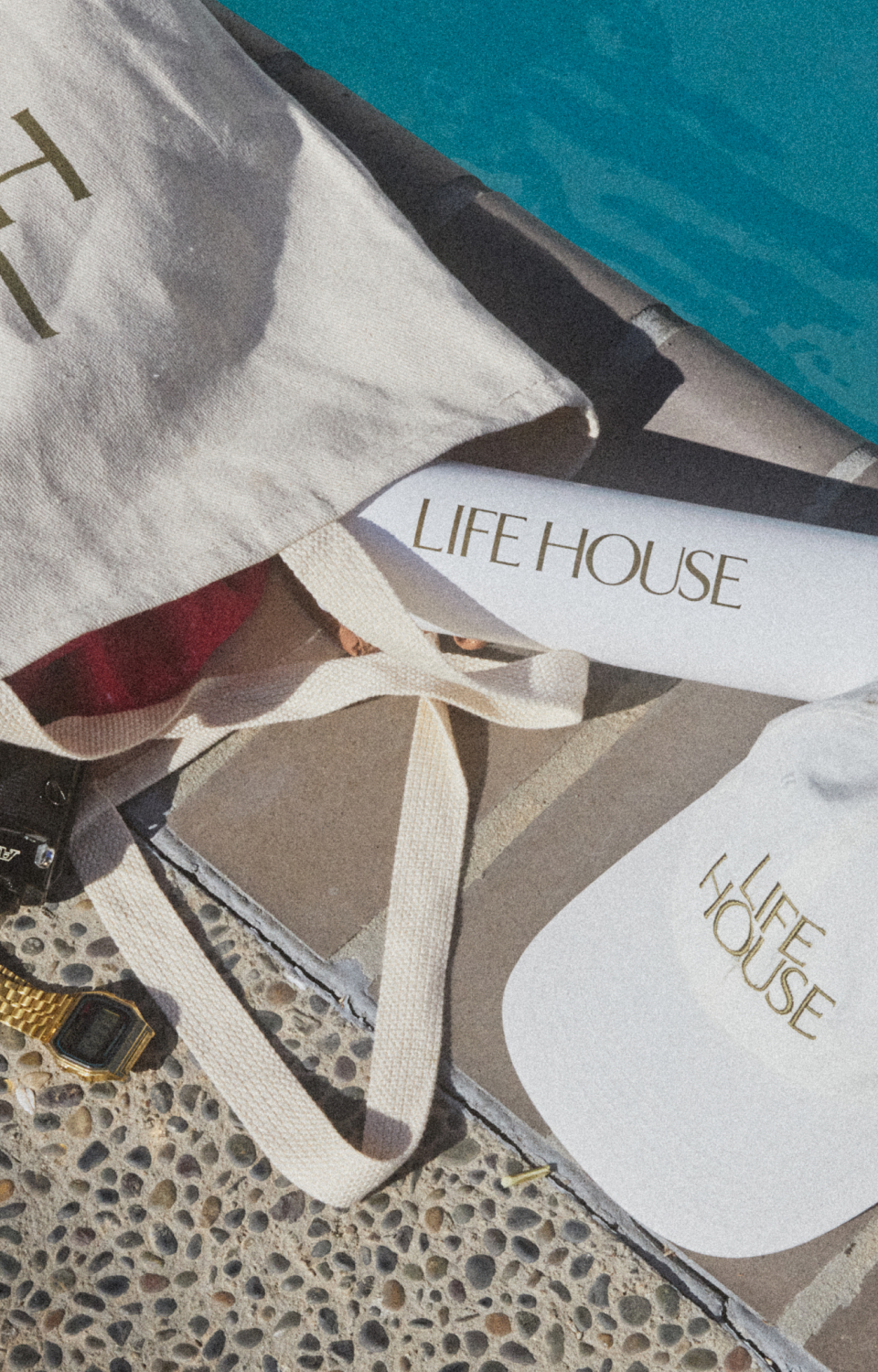 Close up shot of Life House white tote with branded cap and and water bottle