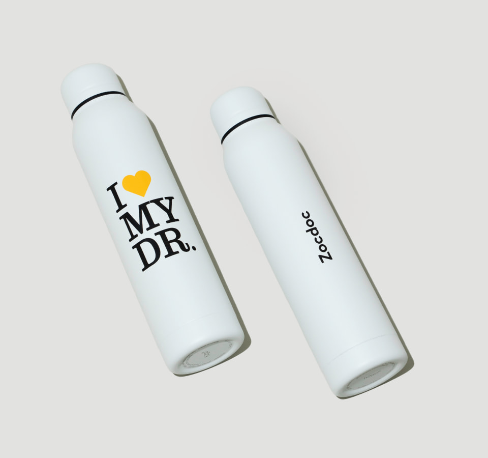 Custom white tumbler with black and yellow branding for Zocdoc