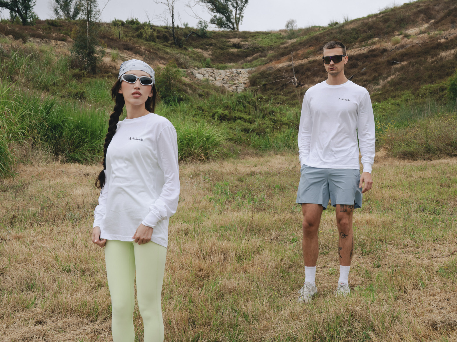 Models wearing white Altitude long-sleeve tees outside