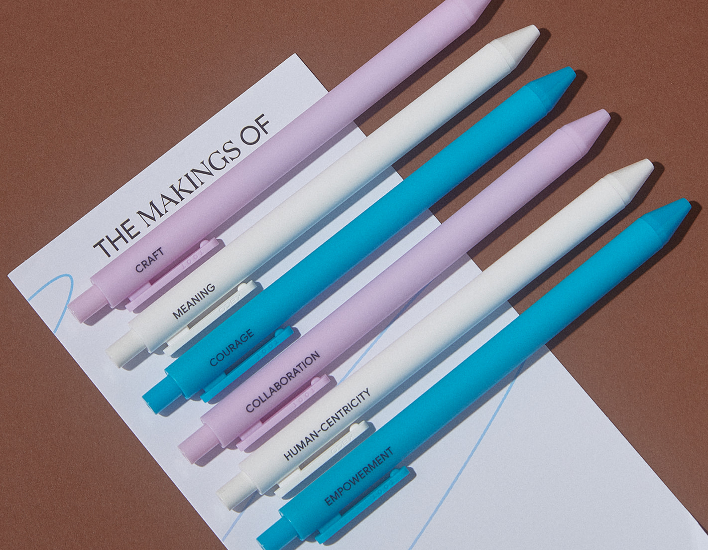 Google custom pastel pens printed with company values including meaning, courage, collaboration, human-centricity, and empowerment