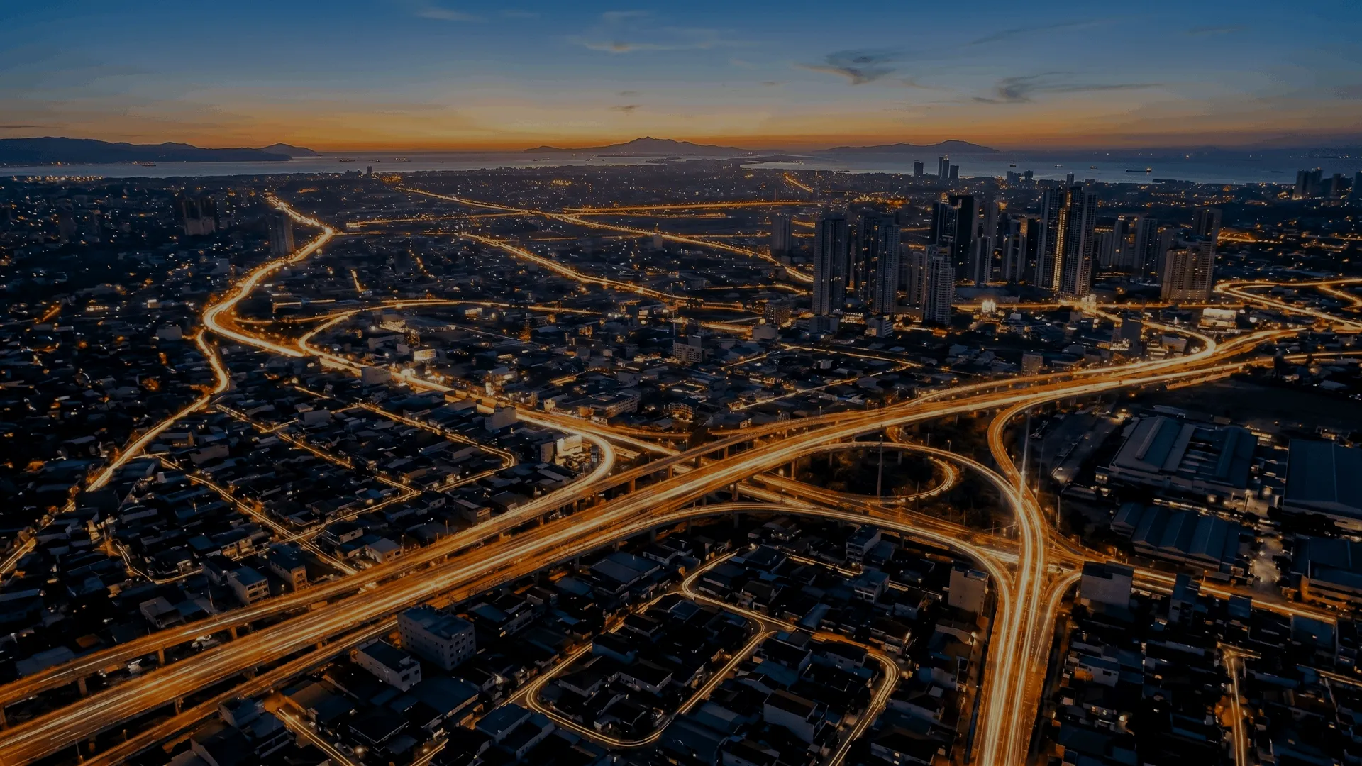 Aerial view of a city highway network at dusk.