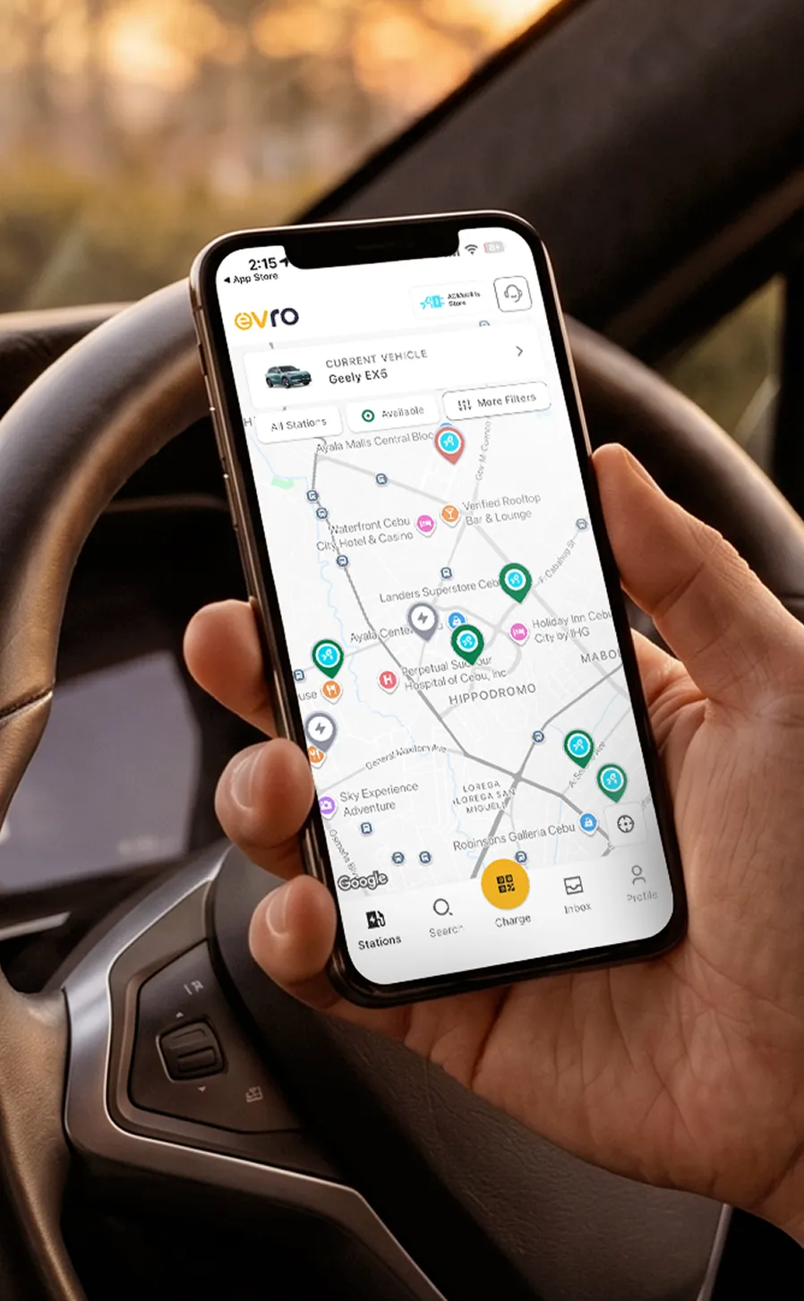 Driver holding the Evro app map inside a car.