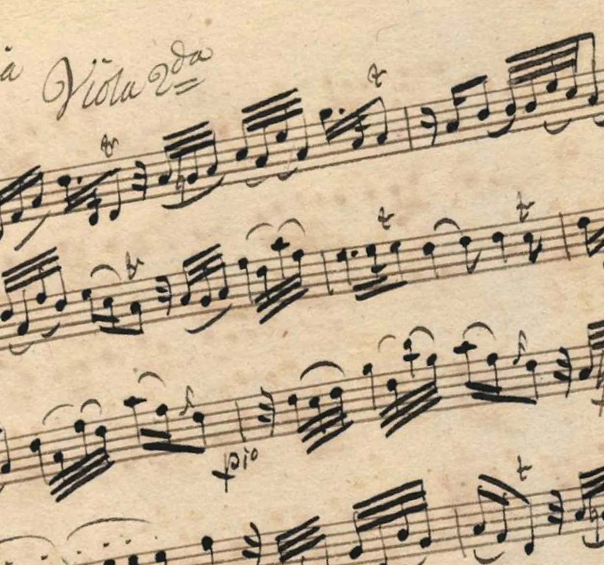 Close-up of handwritten viola sheet music with notes and musical notations on aged paper.