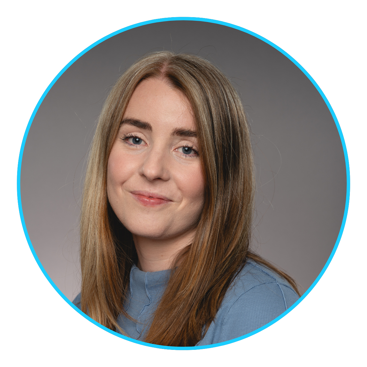 Portrait of a woman with long light brown hair wearing a blue top against a gray background.