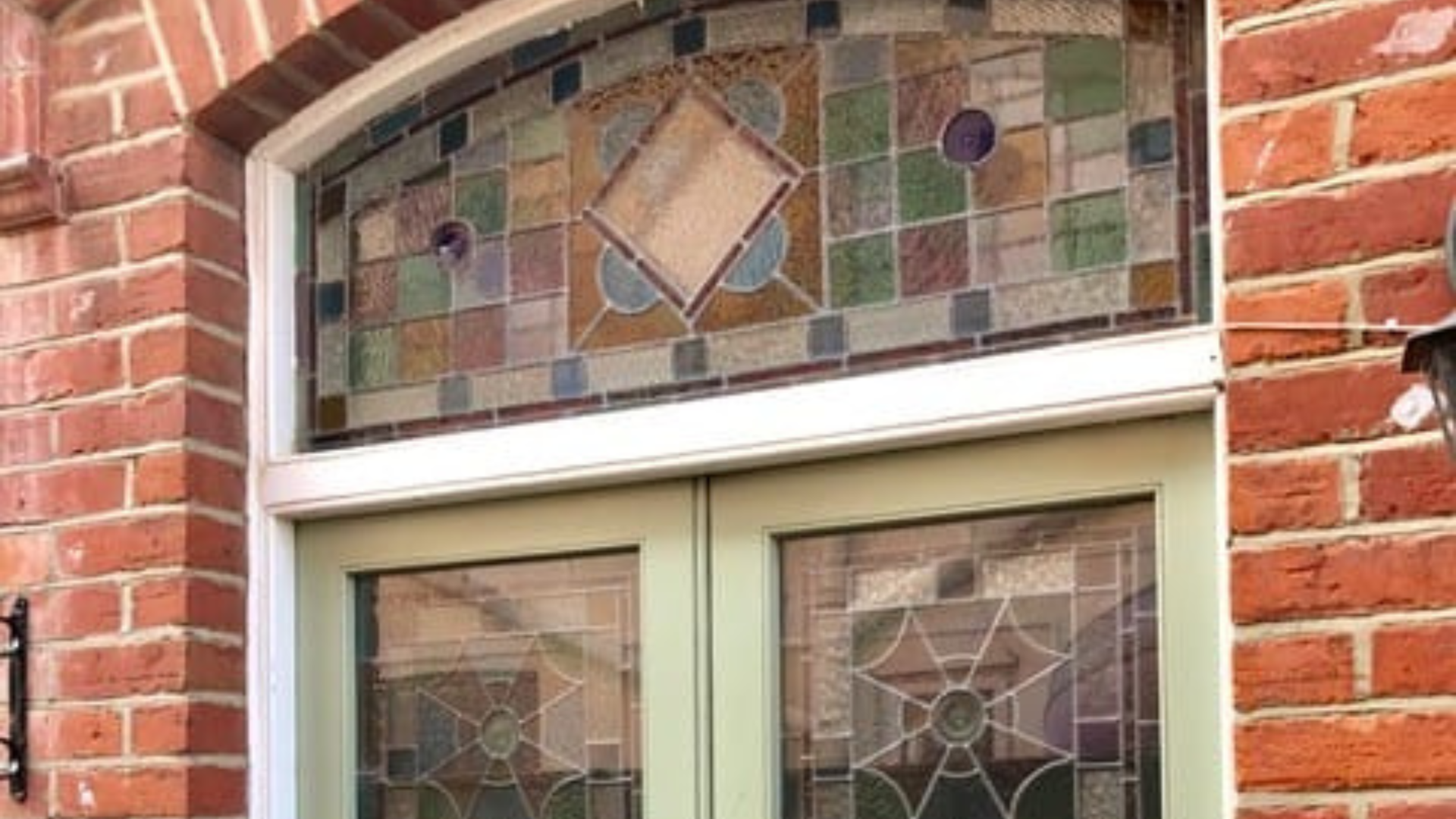 Sage Door with ornate stained glass panels.