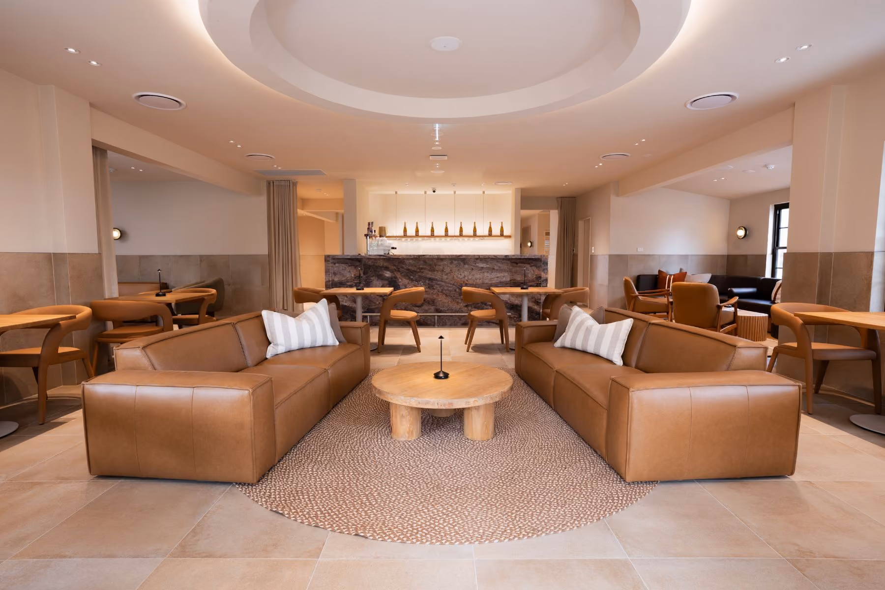 The VELA champagne bar and relaxation lounge, with armchairs beneath a circular ceiling light