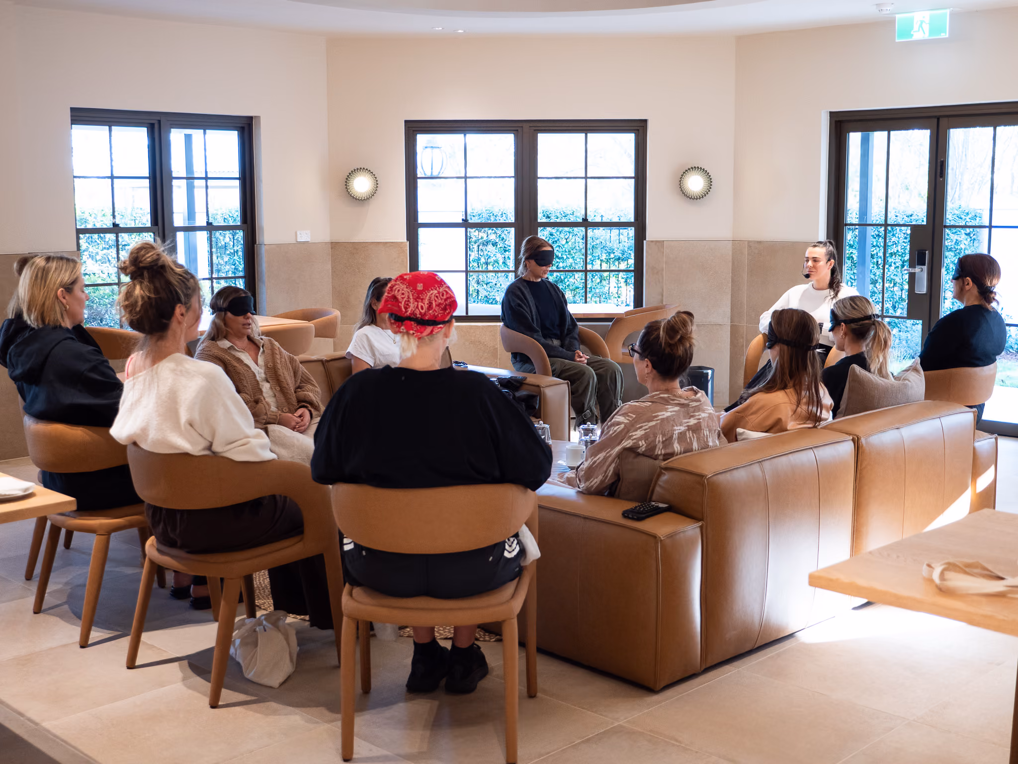 Colleagues in robes sharing tea in the VELA relaxation lounge at dusk