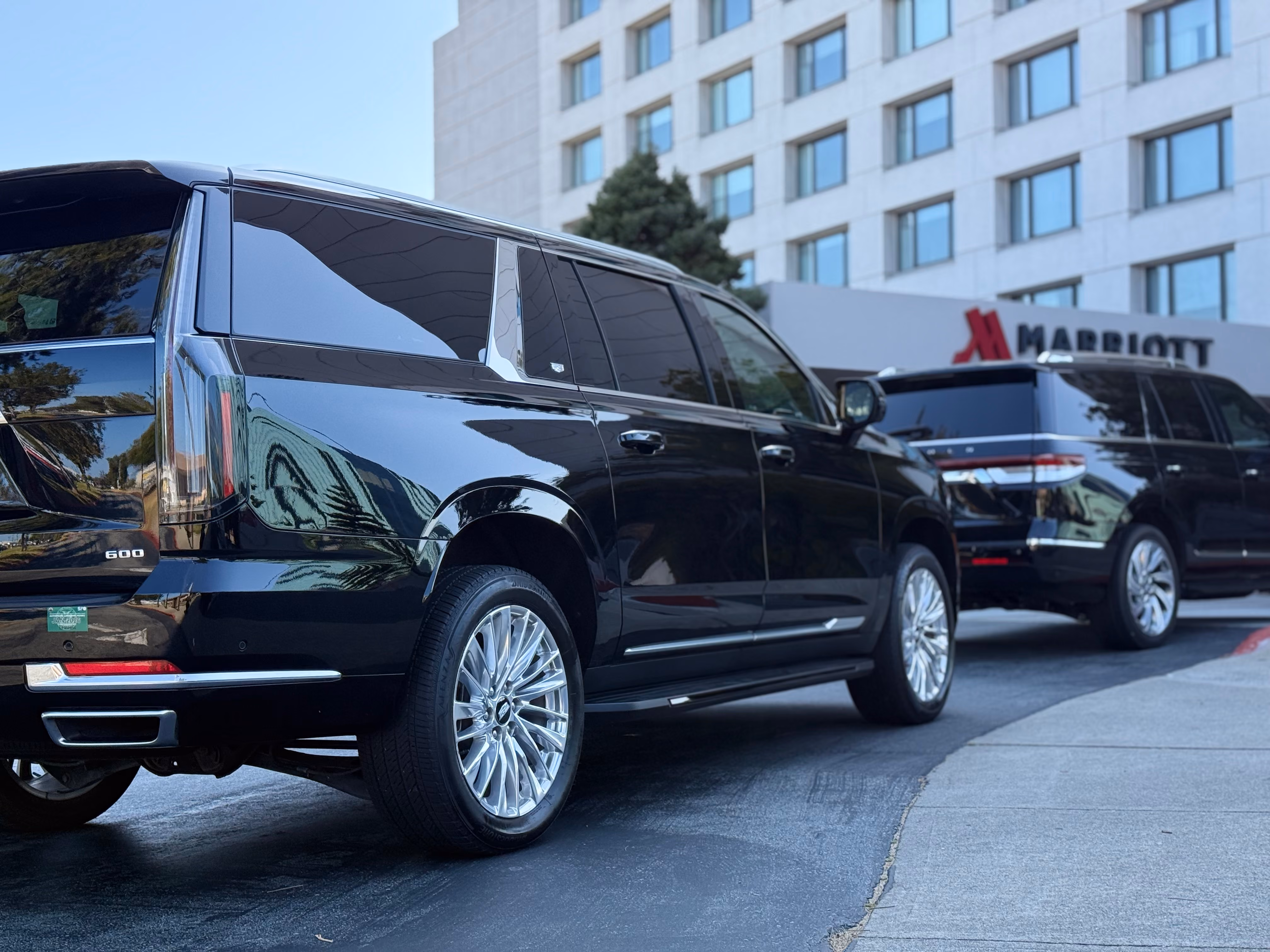 Black Cadillac Escalade at a Marriott hotel entrance with the hotel sign behind