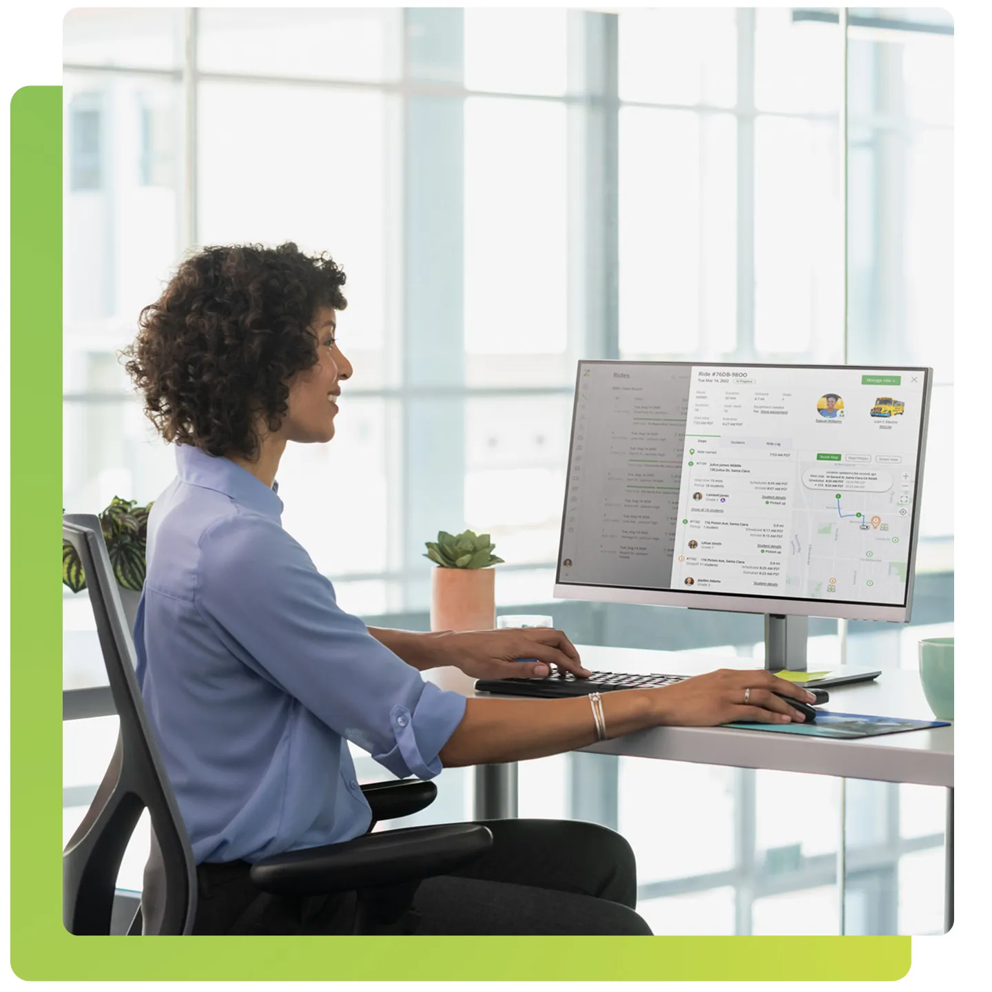 A person using a computer at a desk with a transportation app displayed on the screen.