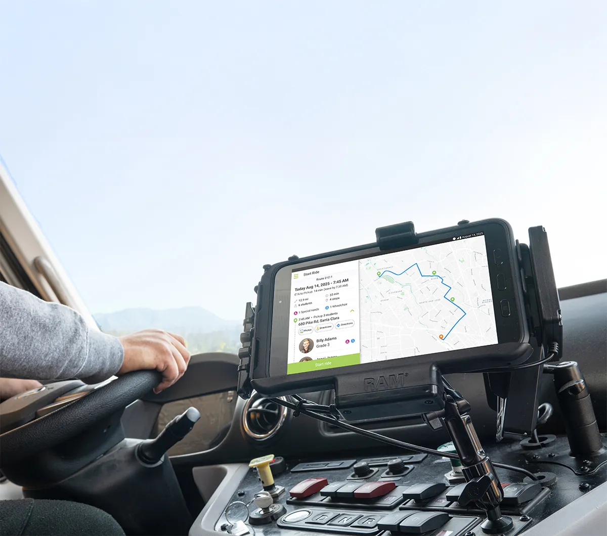 A driver's tablet mounted in a Zum Services, Inc. school bus displaying the day's route and student pickup details.