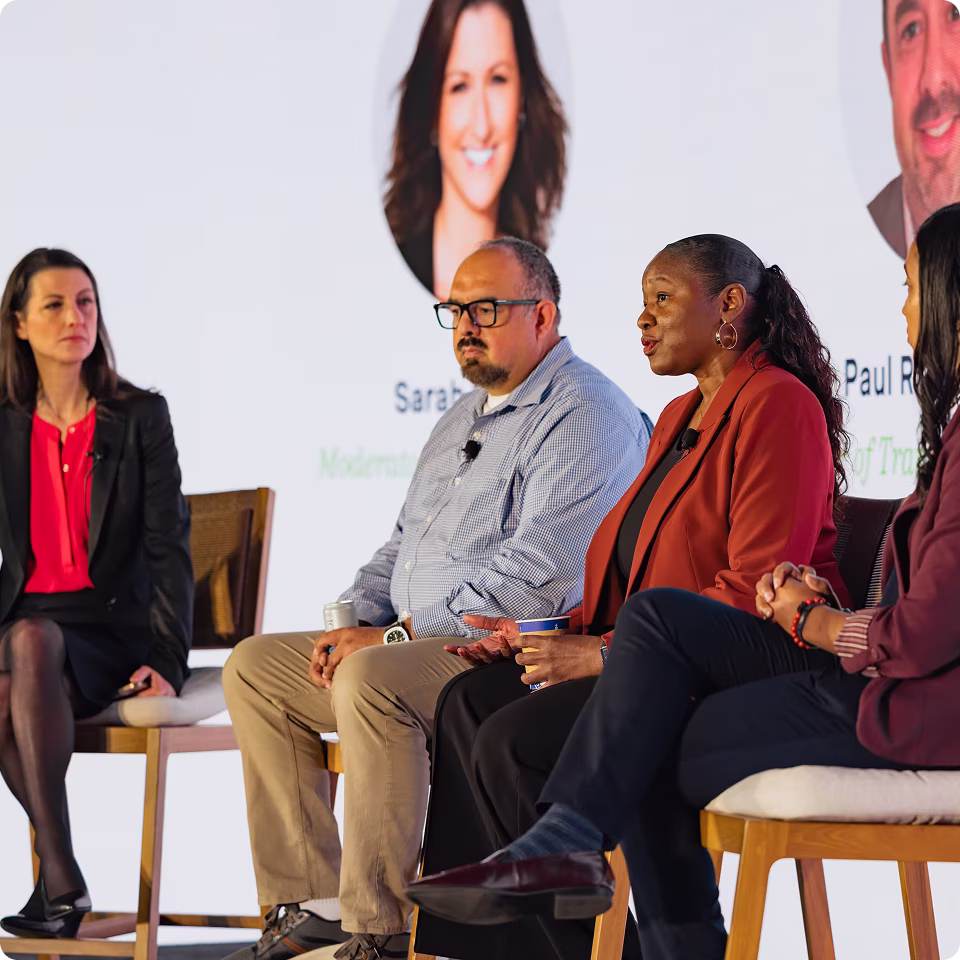 Panel discussion with four speakers discussing school transportation at a conference.
