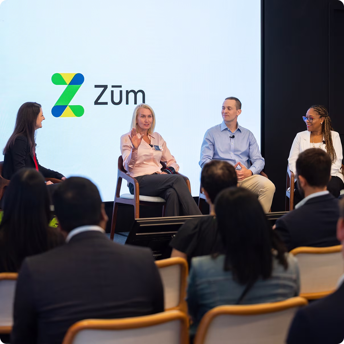 Panel discussion at Zum. Speakers sharing insights on school transportation with audience engaged.