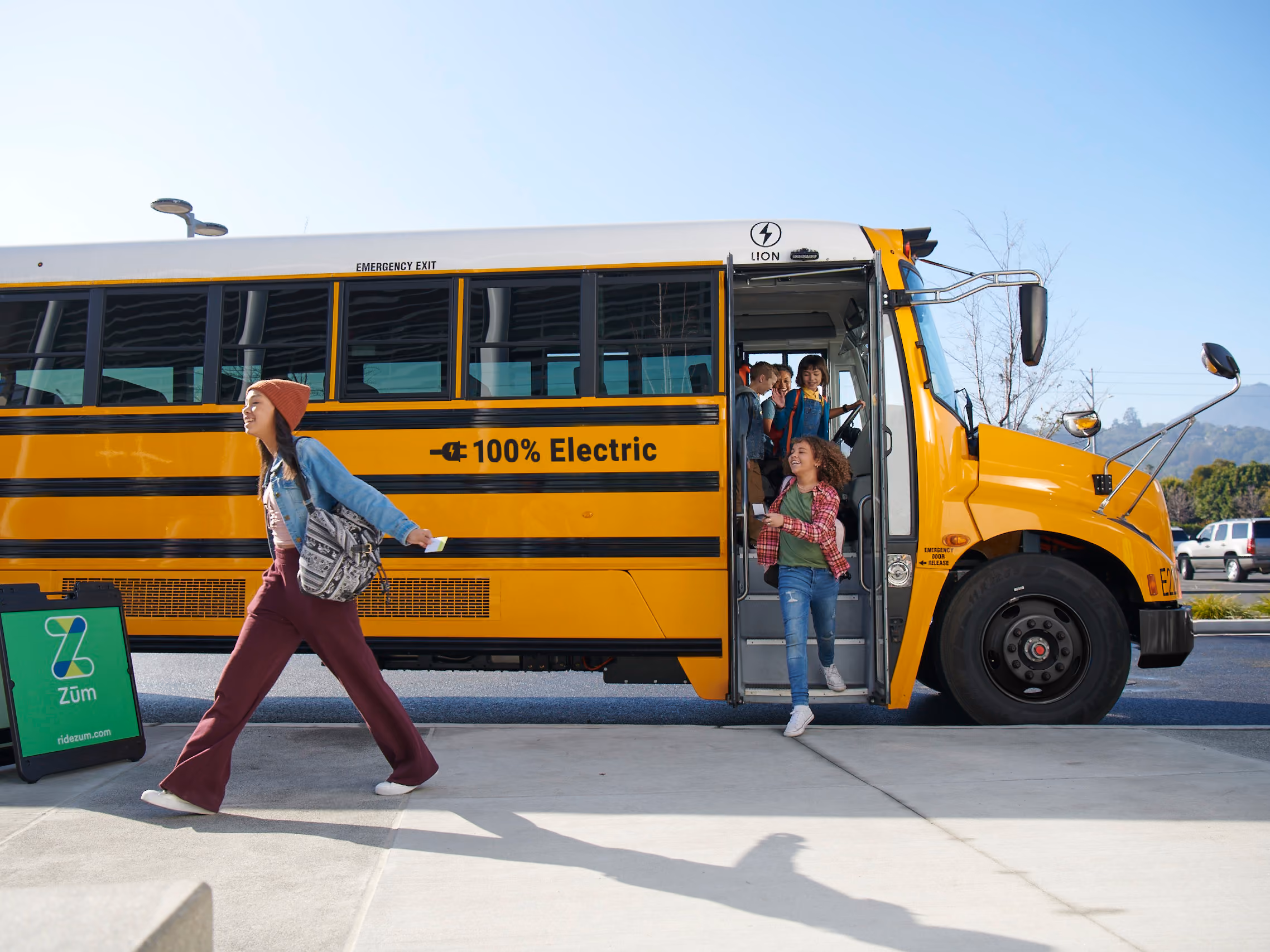 Students boarding or riding a Zum Services, Inc. school bus.
