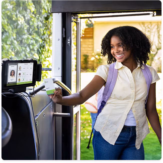 Student tapping RFID card when boarding bus