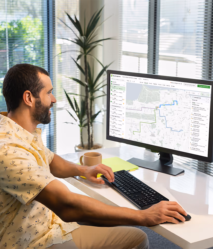 A transportation team member reviewing bus routes on Zum's Route Explorer, with a map view showing stops and route lines.
