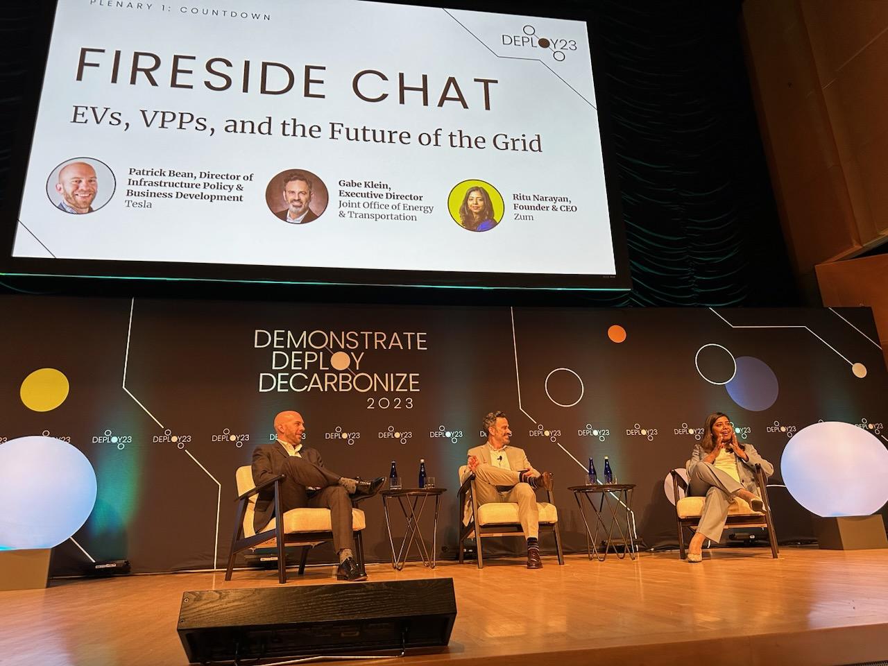 Fireside chat at Deploy23 conference featuring industry leaders discussing EVs and the grid.