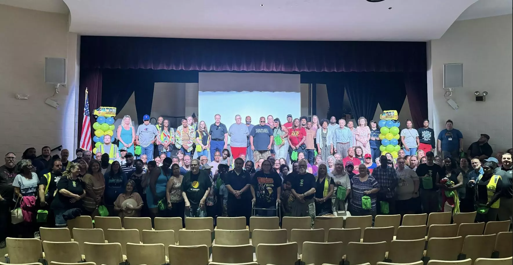 Group of Zum employees and partners posing together on stage at a company event in Roanoke, Va.