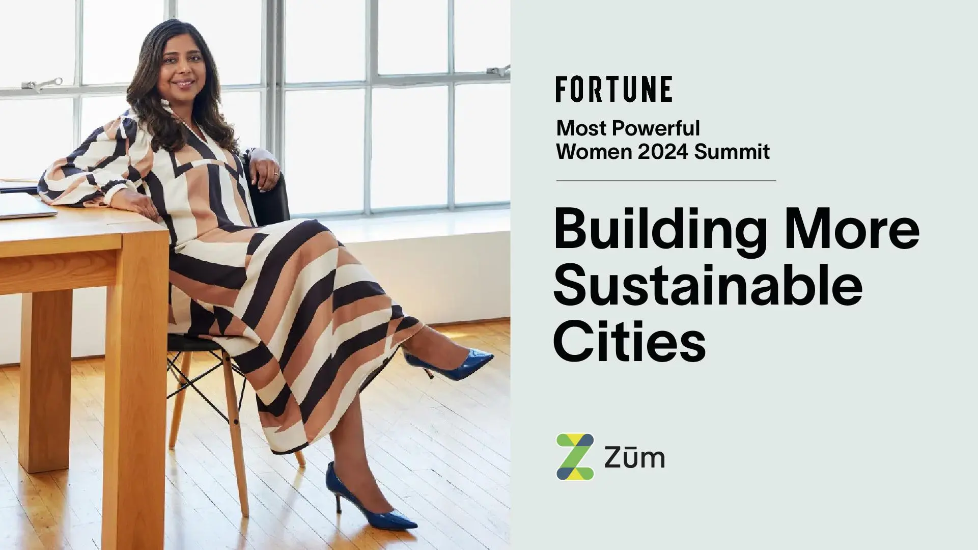 A woman in a striped dress sits on a chair next to a wooden table, highlighting sustainability.