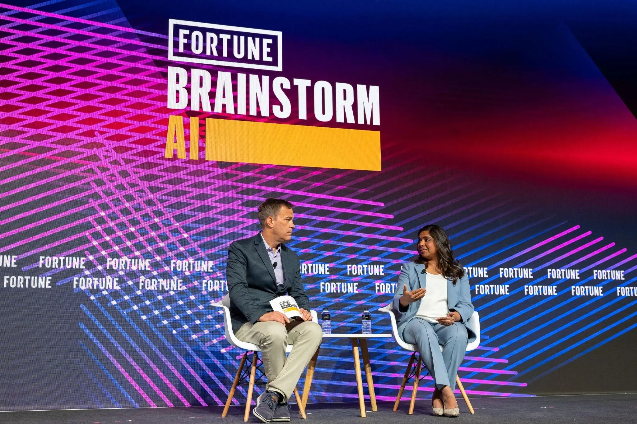 Ritu Narayan and an interviewer on stage at Fortune Brainstorm AI Singapore event.