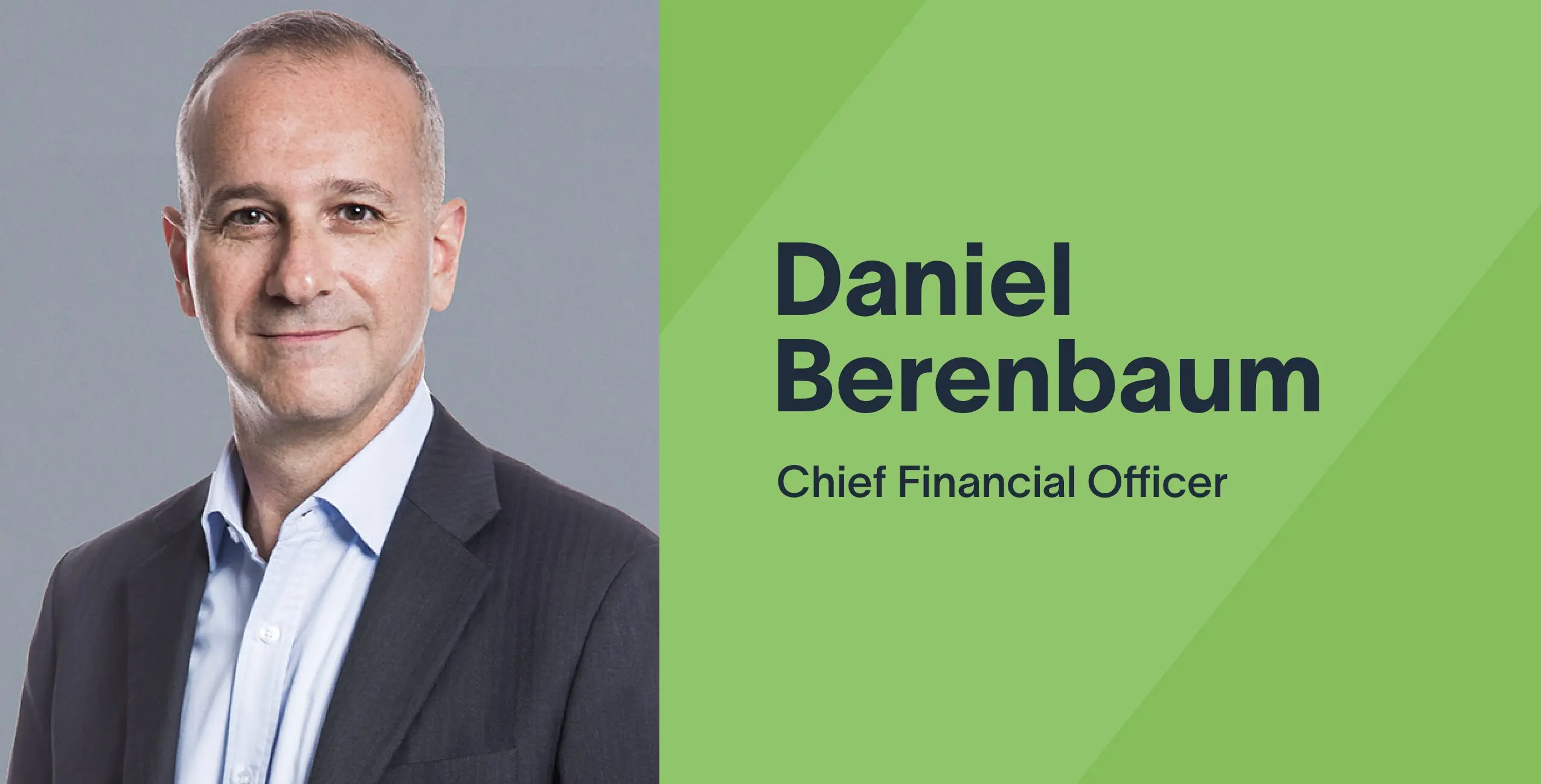 Daniel Berenbaum, Chief Financial Officer of Zum, posing in a business suit against a gray