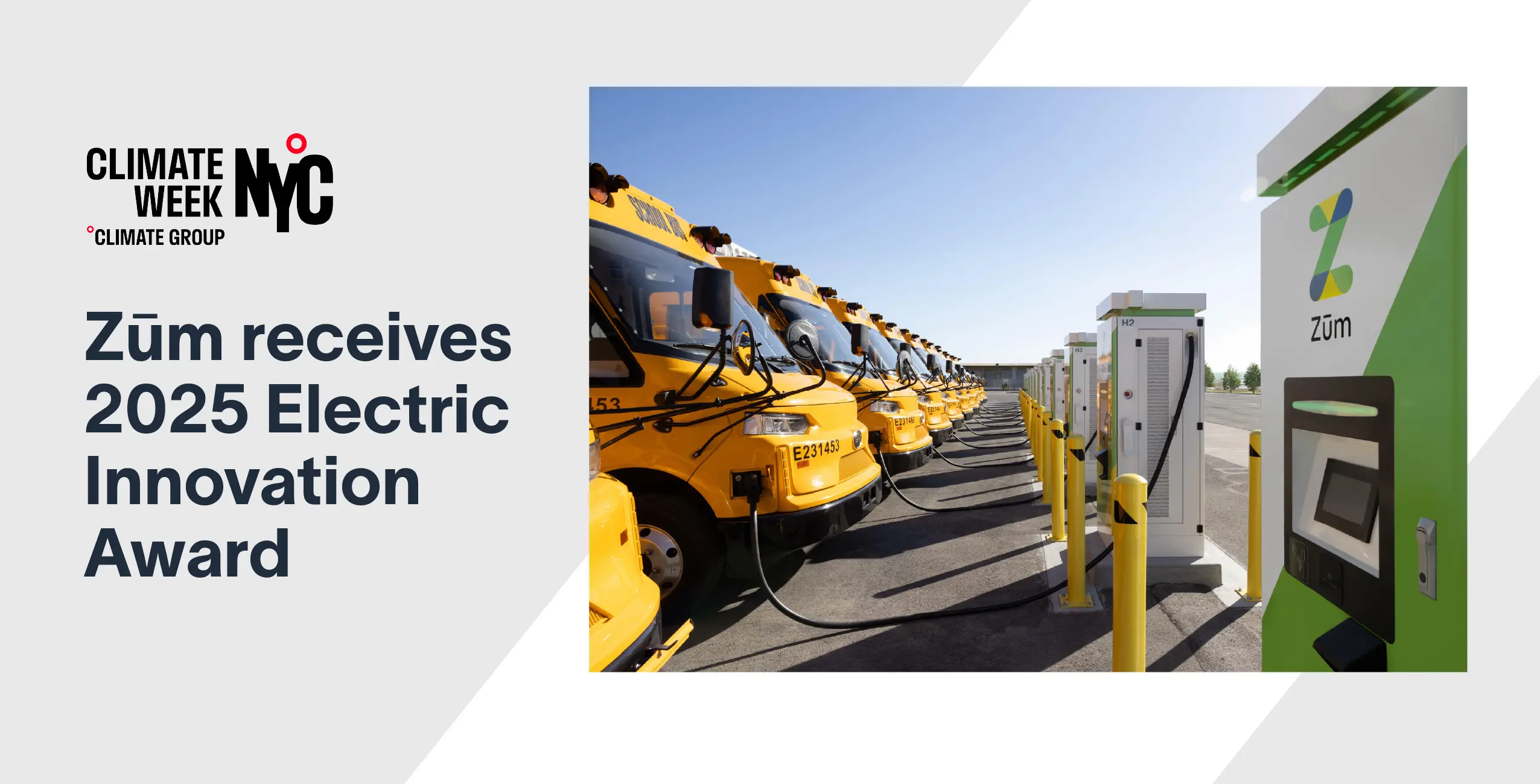 Zum's electric school buses lined up next to EV charging stations for sustainable transportation.