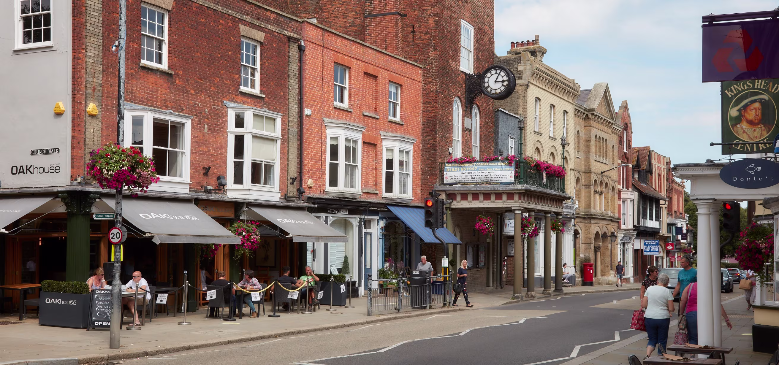 Maldon high street with people walking past the shop fronts.
