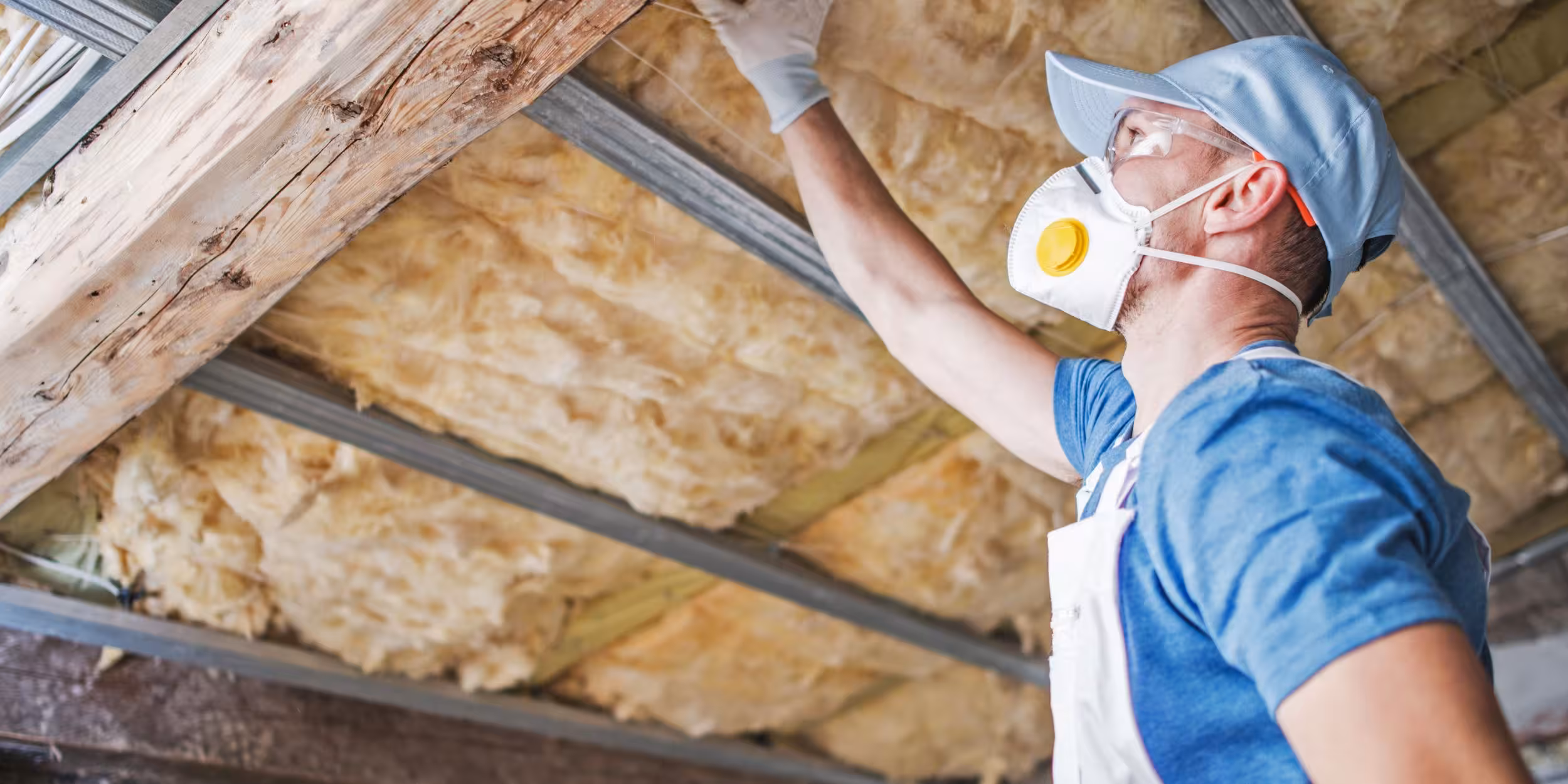 Person installing insulation in home