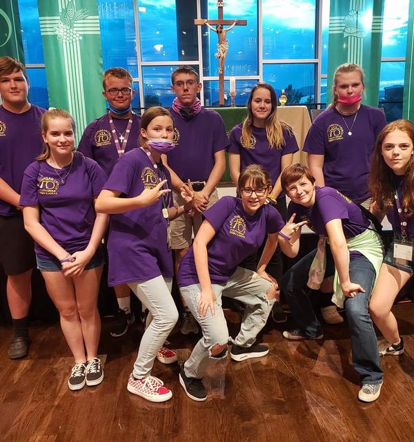 A group of teens from Faith Lutheran Church in Derby at the annual Higher Things conference, wearing their matching purple conference t shirts. 
