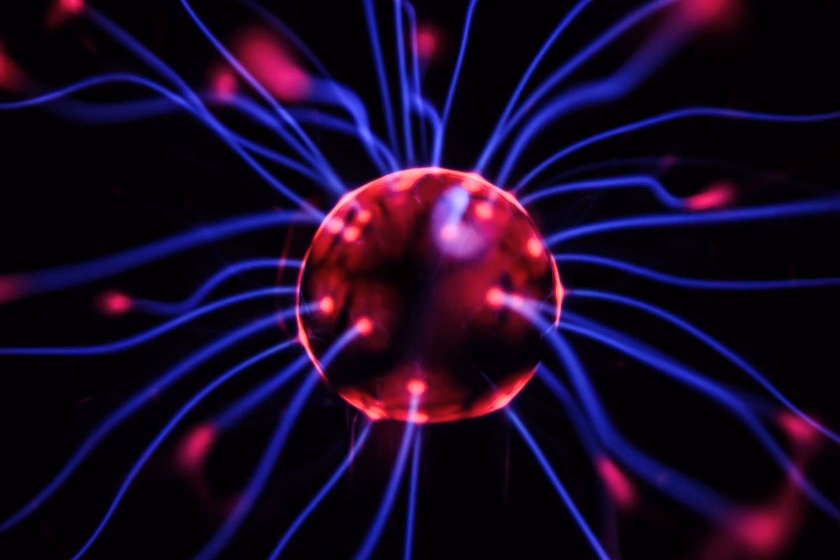 Glowing red sphere with blue energy lines radiating outward on black background