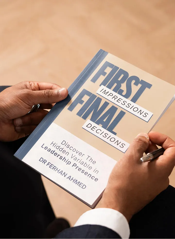 A reader holding 'First Impressions, Final Decisions', the book by Dr Ferhan Ahmed